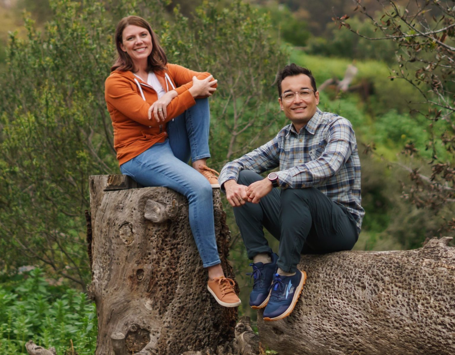 Rebecca and Ren sitting on a tree stump